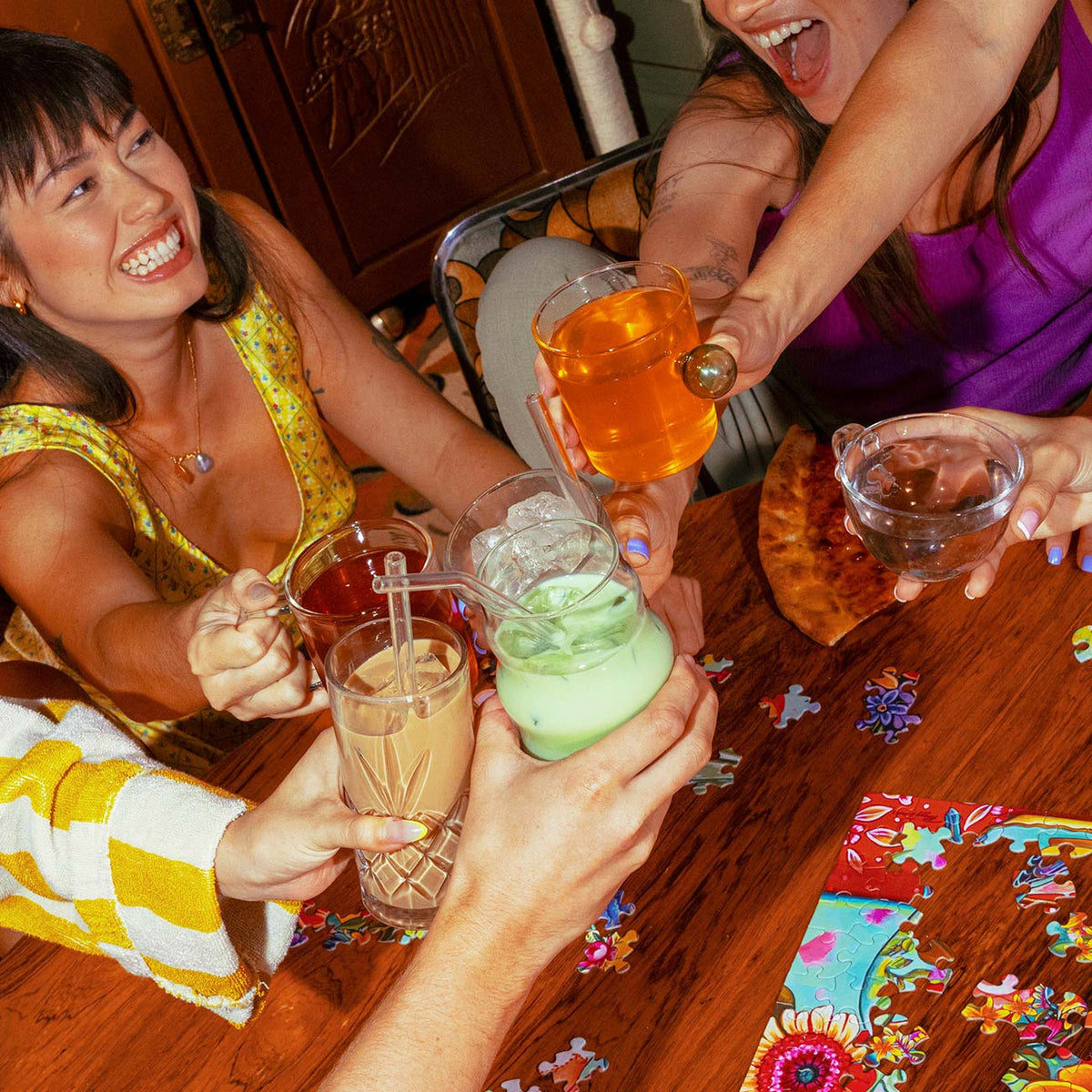 Friends sharing iced Mad Tea lattes around a table
